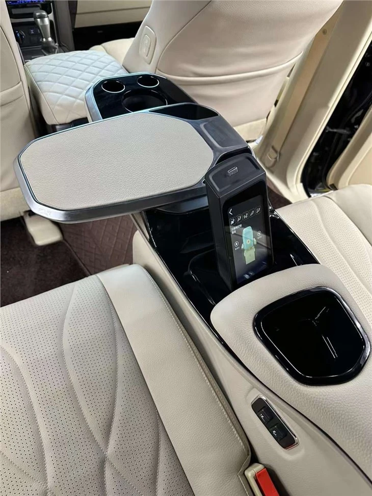 Luxury SUV back seat in Toyota Prado with hidden touchscreen and tray table